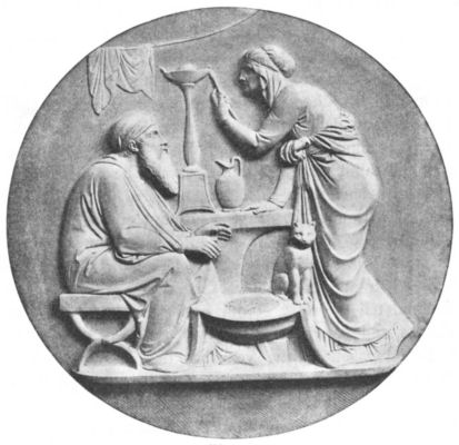 Bas-relief of an old man and a cat sitting as an elderly woman lights a lamp