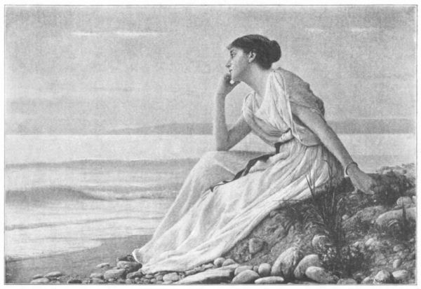 A young woman sits on the shoreline and stares out to sea