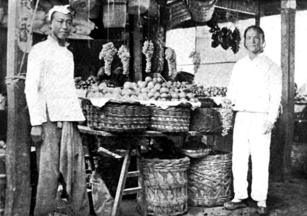 Two men at a fruit stall