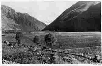 Fig. 43—The floor of the Urubamba Valley from Tarai. The work of the glaciers was not confined to the lofty situations. Mountain débris was delivered to all the streams, many of which aggraded their floors to a depth of several hundred feet, thus increasing the extent of arable soil at elevations where a less rigorous climate permits the production of crops and encourages intensive cultivation.