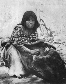 A Wallapai Woman pounding Acorns.