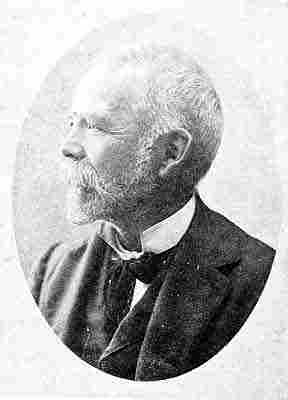 White hair and neatly trimmed beard, walrus moustache; velvet bow tie; jacket and vest.